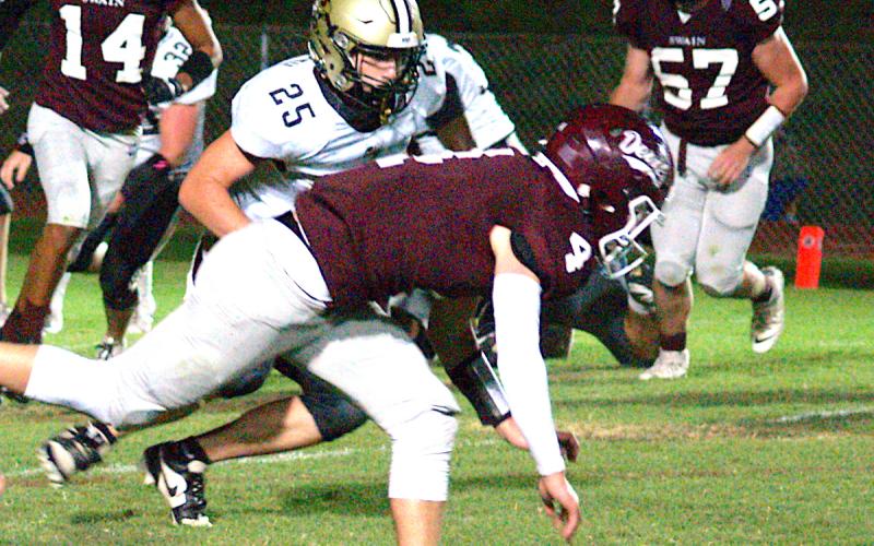 Gary Corsair• Clay County Progress Kaden Ledford, No. 25, lowers the boom on Swain's Rocky Barker, No. 4.