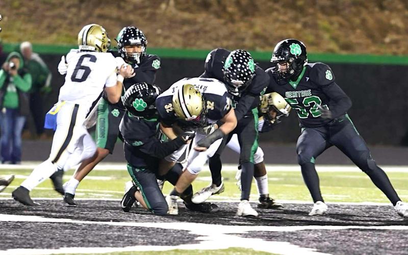 Photo by Keith McCurry Hayesville's Dawson Devane, No. 32, bullies his way through the Mountain Heritage defense as Tre Graves, No. 6, supplies a block.