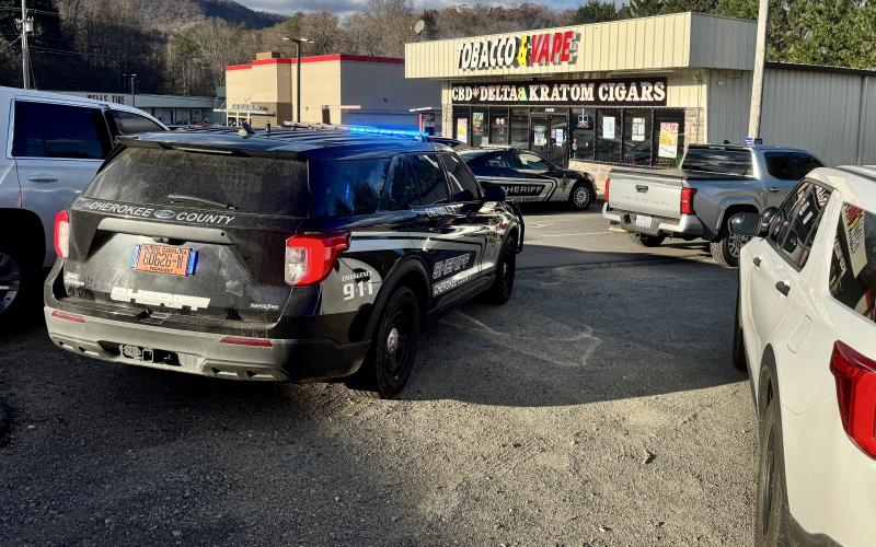 Randy Foster • Cherokee Scout Cherokee County sheriff's deputies and Murphy Police Department officers at a drug raid at Tobacco &amp; Vape store off Andrews Road in Murphy on Friday afternoon. Two people were taken into  custody during the raid in Murphy, with one released and the other,  Wyle Radwan Alsalme, 21, of 1508 Andrews Road, Murphy, Alsalme  charged with possession of a schedule I controlled substance and released in lieu of $10,000 bond. The raid was part of a three-county operation in Clay, Cheroke