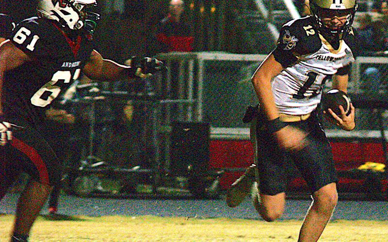 Gary Corsair • Clay County Progress Hayesville quarterback Lance Coker, No. 12, abandons plans to pass and turns on the afterburners to elude an Andrews pursuer.