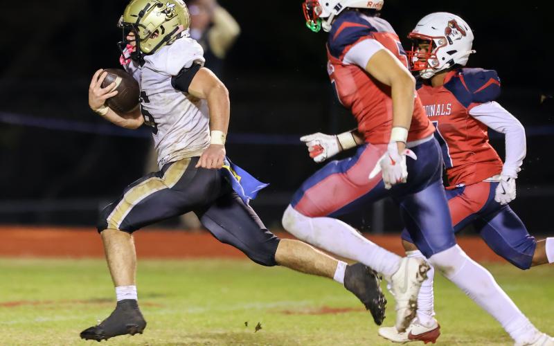 Photo by Marc Lancaster Tre Graves, No. 6, leaves a pair of Cardinals in the dust as he races to a 42-yard touchdown that tied first-round playoff game at Union Academy, 28-all.