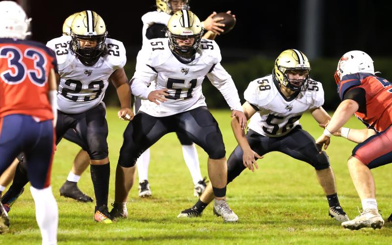 Photo by Marc Lancaster Hayesville lineman E.J. Mapasua, No. 23, Brendon Collins, No. 51, and E.J. Abrams, No. 58, protect quarterback Tate Roberts with the skill of Secret Service bodyguards.