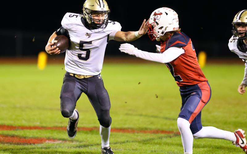 Photo by Marc Lancaster Tate Roberts, No. 5, straight arms a Union Academy defender on the way to a first down.