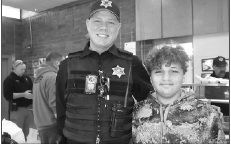 Deputy Sean Stout, left, received the help of AJ Austin in delivering meals to those who could not attend. Austin said it was his first year volunteering, but it won’t be his last. “I loved it,” he said.