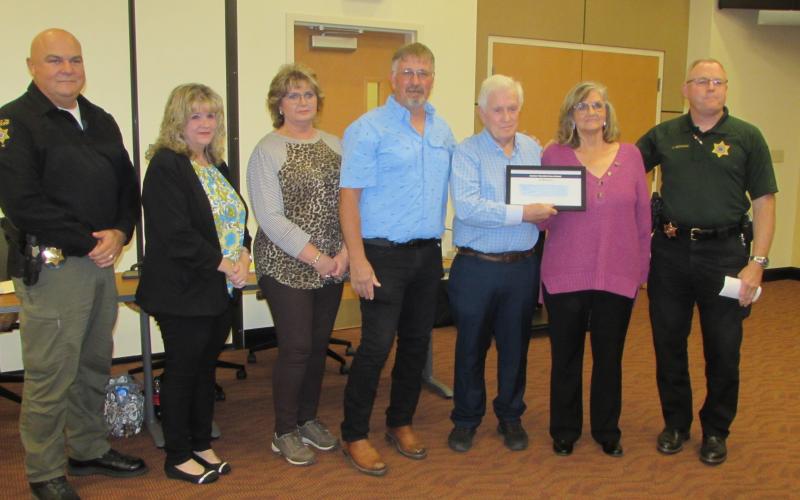 Lorraine Bennett • Clay County Progress From left, Todd Wingate, Renee Penland, Tarena Davenport, Robert, Leon Sr., Irene Penland and Sheriff Mark Buchanan during recognition at the commissioners meeting last week.