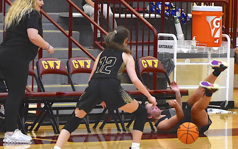 Gary Corsair • Clay County Progress Aaliyah Jackson tumbles across the floor after saving the basketball from going out of bounds by slapping it to Olivia Free, No. 12.