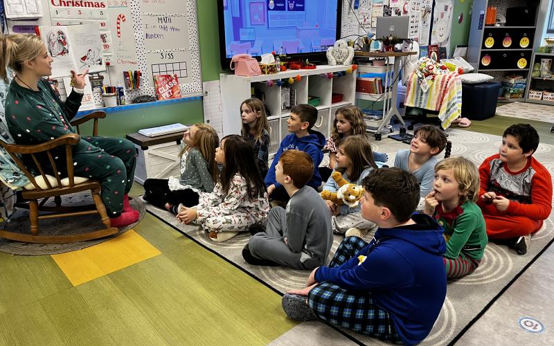 Deby Jo Ferguson • Clay County Progress Hayesville Primary School held pajama day on Friday, Dec. 20, right before the Christmas holiday. First grade teacher Annie Brooks shares storytime with the students who are nestled around her in their pajamas.