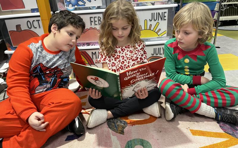 Deby Jo Ferguson • Clay County Progress Sharing a book with friends is always fun on pajama day. From left is Isaiah Cline, Kaytney and Arthur Diesz.