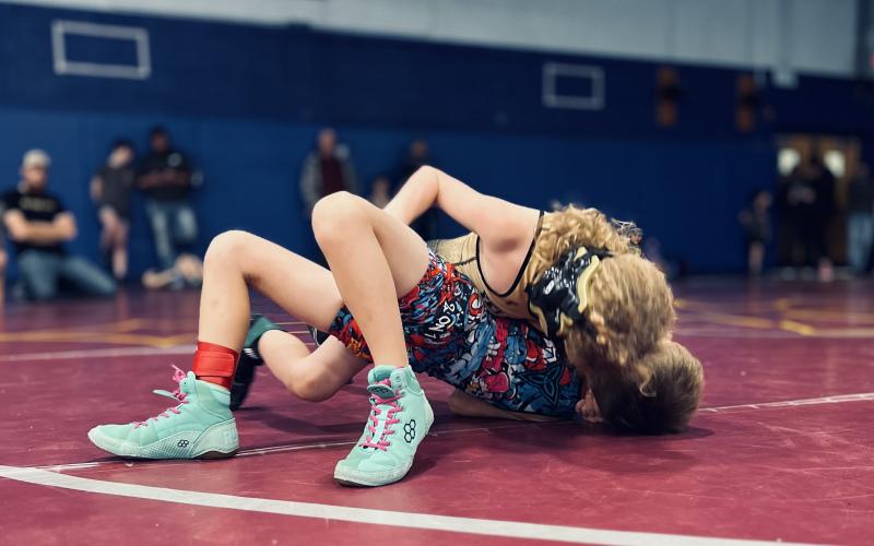 Caycen Hill pins his opponent.