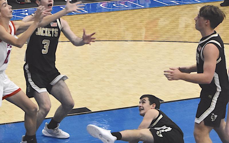 Gary Corsair • Clay County Progress Slade Crouch, No. 3, battles for the basketball as Riley Rogers, No. 11, and Landon Trout, No. 15, watch during a holiday tournament battle. Crouch continues to be a formidable force at both ends of the floor for Hayesville.