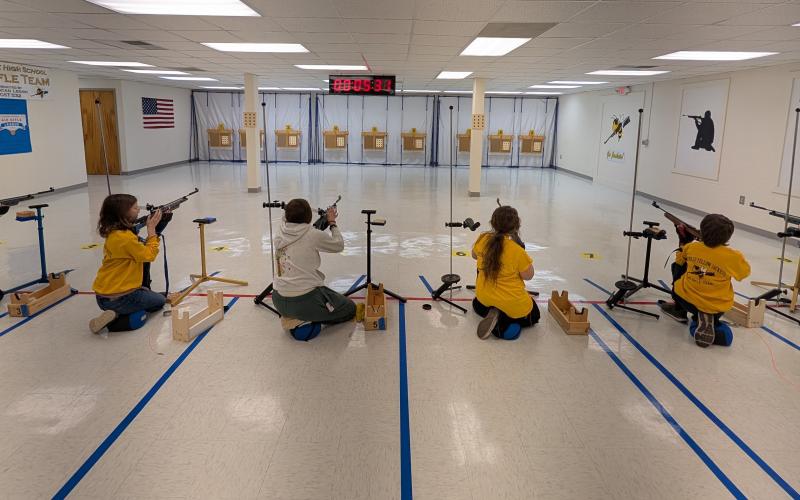 The Hayesville Yellow Jacket Air Rifle Team, from left, Zoe Angelopulos, Maggie McClure, Wednesday Johnson and Masyn Parrinello compete in the kneeling position.