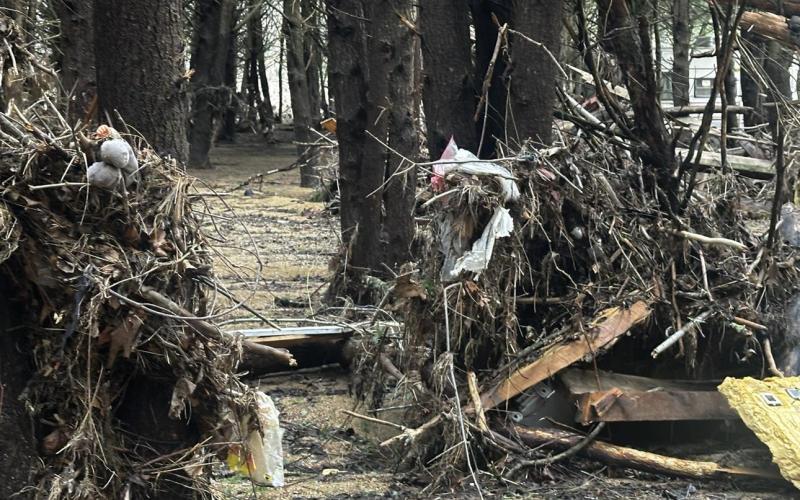 Lorrie Ross • Clay County Progress Walking along any of the riverbanks, there are log jams and huge piles of natural debris combined with remnants of peoples' lives. These stacks of debris piled against trees along the Doe River contain a lot of what must have been important to someone. There is a baby doll, a new door frame, some lumber, a smashed shower unit, a full size fridge, as well as lots of tiny pieces of trash.