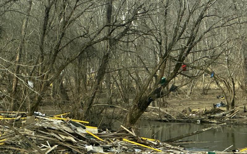 Lorrie Ross • Clay County Progress Debris from Impact Plastics and other destroyed buildings litter the riverbanks and hang from the trees a couple of miles from the factory.