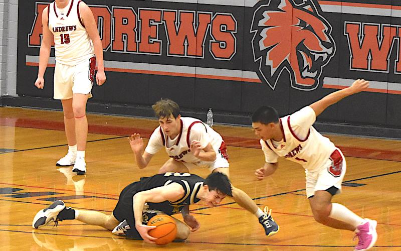 Gary Corsair • Clay County Progress Hayesville's hopes of tying the score against Andrews disappeared on this play when two Wildcats converged on Slade Crouch, No. 3, wrestled the ball away from him and scored a final basket.