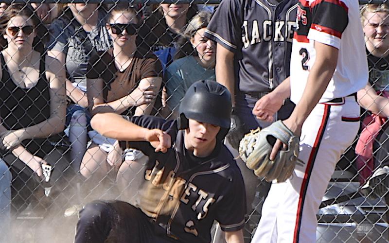 Gary Corsair • Clay County Progress Jacob Cody arrives home in a cloud of dust during Hayesville's lopsided win over Andrews.