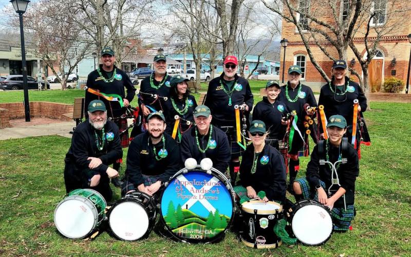 Sandy Zimmermann • Photo The Appalachian St. Andrew’s Pipes &amp; Drums musicians are, front from left, Mike Campbell, side drum; Brian Gatti, drum sargeant; Jeff Mackin, bass drum; Jennifer Lombardo, tenor drum, and Mason Campbell, side drum; back from left, Bill Lombardo, pipe sergeant; Jerry Cannon, piper; Emma Campbell, piper; Ron McInnis, pipe major; Richard Smith, piper and Leslie Jones, piper performed classics with a mix of American tunes during the Irish Bash Sunday, March 16 on Church Street.