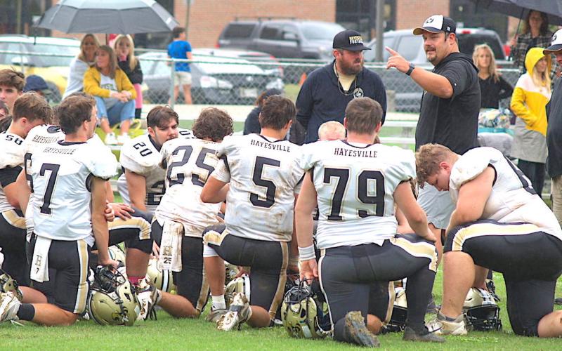 Coach Chad McClure coaching the football team.