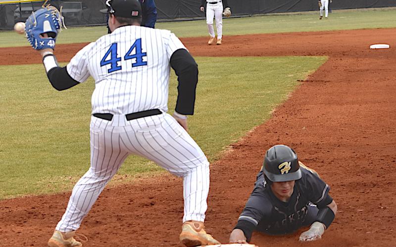 Gary Corsair • Clay County Progress Yellow Jackets shortstop Tate Roberts dives back to the bag in time during a pickoff attempt last week.
