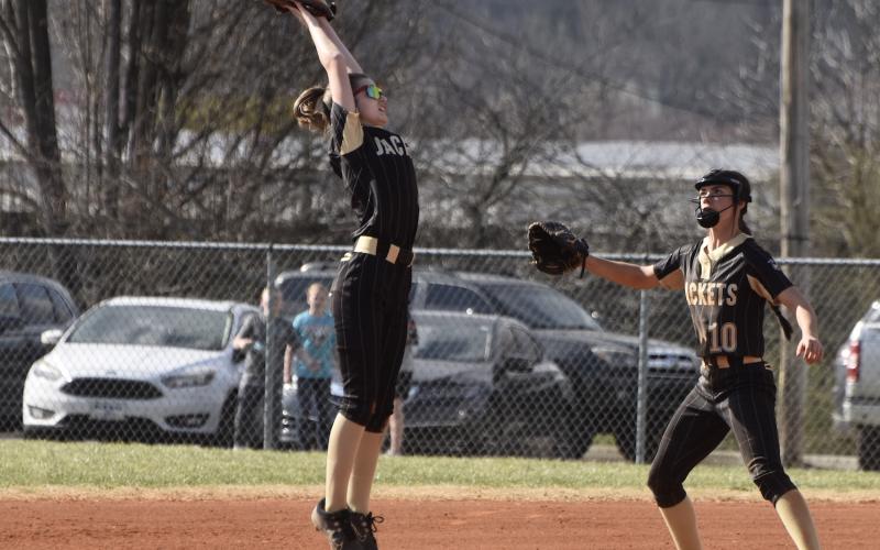 Gary Corsair • Clay County Progress Hayesville's Lillie Chastain leaps to catch a high throw during a rundown against Andrews as winning pitcher Micalynn McClure, No. 10, arrives to help nab the Wildcat base runner.
