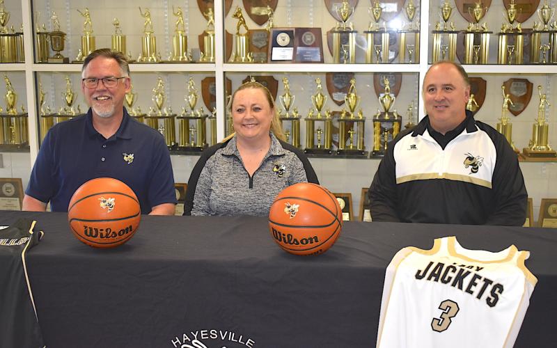 Gary Corsair • Clay County Progress Hayesville High School Principal Stacey Overlin, left, and Athletic Director Mike Cottrell present Tammy Jones Dills as the new varsity girls basketball coach.