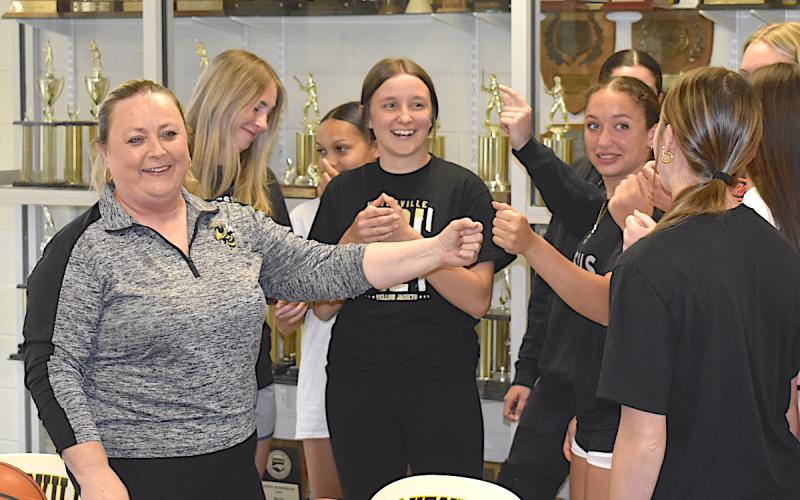 Gary Corsair • Clay County Progress Tammy Jones Dills and her varsity girls basketball team "bring it in" after Dills was named