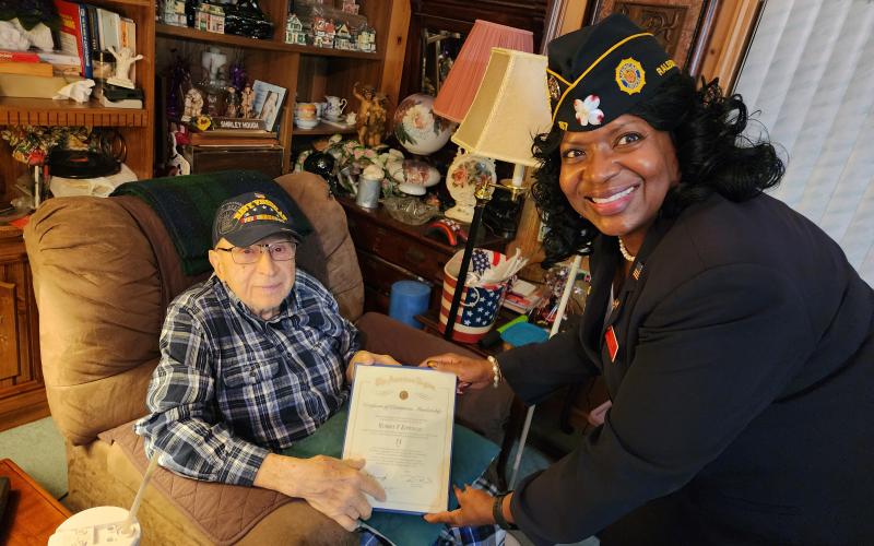 Bob Epperson receives his certificate of membership from Patricia Harris.