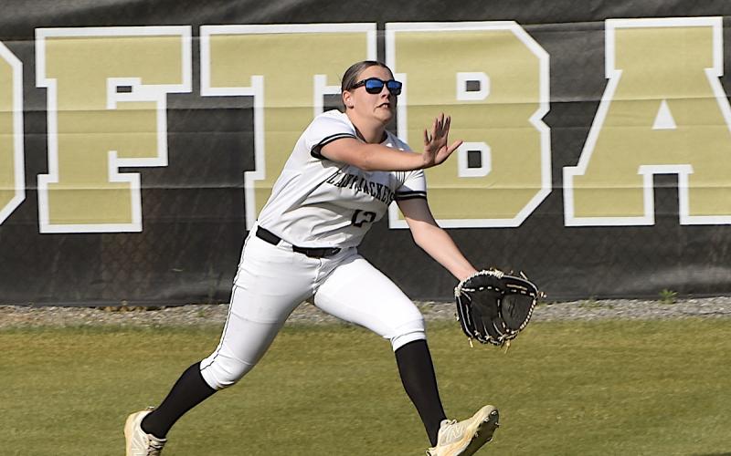 Gary Corsair • Clay County Progress Hayesville left fielder Lillie McClure goes all out for a fly ball hit by Cherokee.