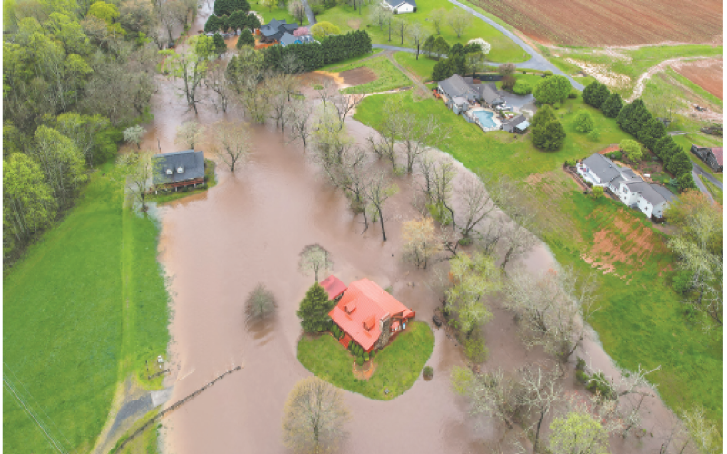 Ron Wallace Photo A home in the River Oaks community appears to stand on its own island after the creek overflowed.