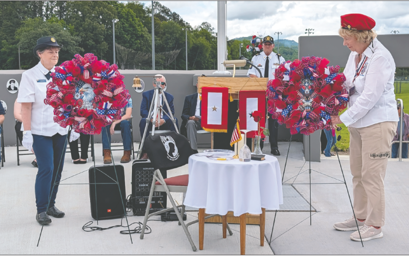 Photo by Dwayne Bradley American Legion Auxiliary member Teresa McClure, left, and VFW Auxiliary member Helen Davis, conduct the traditional laying of the wreaths on center stage.