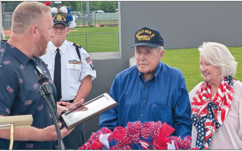 Photo by Dwayne Bradley Commission Chairman Dr. Rob Peck, left, and Betty Bradley honor 100-year-old veteran, Ralph Myers during the dedication of the Veterans Park on Memorial Day. The day combined two events, remembrance of those who sacrifi ced their lives for their country and the debut of the park honoring all veterans. In the foreground are veterans Carl Maxwell and VFW Commander John Clodfelter who led the Memorial Service.