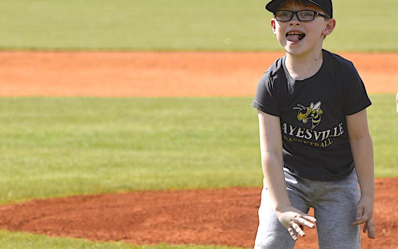 Six-year-old Cooper Godfrey, son of Jamie and Melissa Godfrey, throws out the first pitch prior to Hayesville’s 3-0 victory over Mitchell in the first round of the North Carolina High School Athletic Association 1-A playoffs Tuesday at Scott D. Penland Baseball Field. The No. 8 seed Yellow Jackets meet No. 24 seed Mountain Island Charter School in the second round on Friday.
