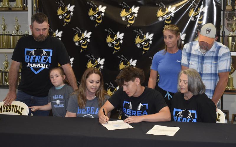 Gary Corsair • Clay County Progress From left, Barrett, Brynlee and Crystal Woody, Michael Mauney, Moriah Mauney, Mike Mauney, Brenda Carder witness Mike signing with Berea College, a liberal arts institution in Berea, Ky.