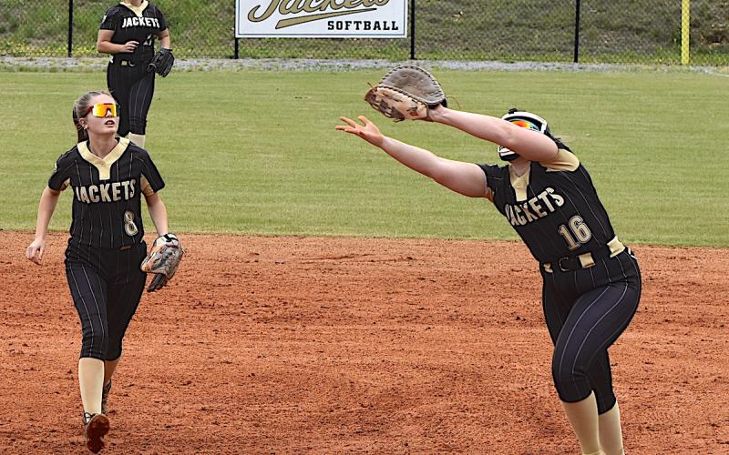Gary Corsair • Clay County Progress Hayesville first baseman Danielle Anderson, No. 16, reaches for a pop-up as teammates Lily Chastain, No. 8, and Kyla Bauer, No. 17, look on.