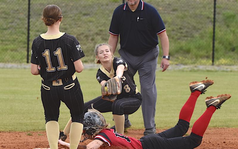 Gary Corsair • Clay County Progress Lily Chastain, No. 8, gloves a throw from home as Raylyn Taylor, No. 11, watches during an Andrews steal.
