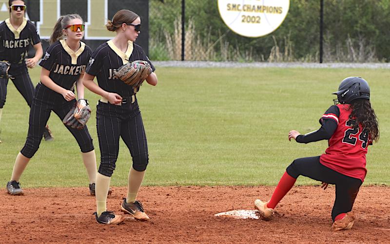 Gary Corsair • Clay County Progress A trio of Lady Jackets descend on second base as an Andrews batter arrives. That's Raylyn Taylor, No. 11, Lily Chastian, No. 8, and Micalynn McClure, No. 10, making sure the Wildcat stops at two