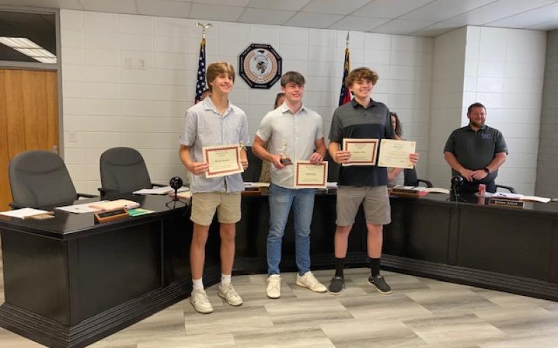Marcia Barnes • Clay County Progress From left, Brady Reynolds, Slade Crouch and Jackson Sellers were recognized for Men’s 2024/2025 Basketball All Smoky Mountain Conference at the Clay County School Board of Education meeting. Back board member Josh Ashe congratulates the students.
