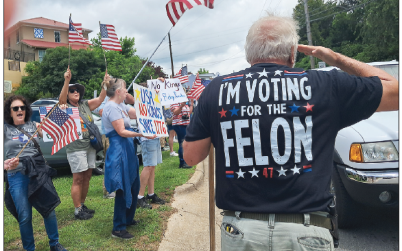 Becky Long • Clay County Progress Jerry Moore, of Clay County, salutes one of the cars in the pro-Trump caravan. He walked up and down the sidewalk through the lines of citizens, shouting “Trump! Trump! Trump!” Moore said, “I have a right to protest, too.”