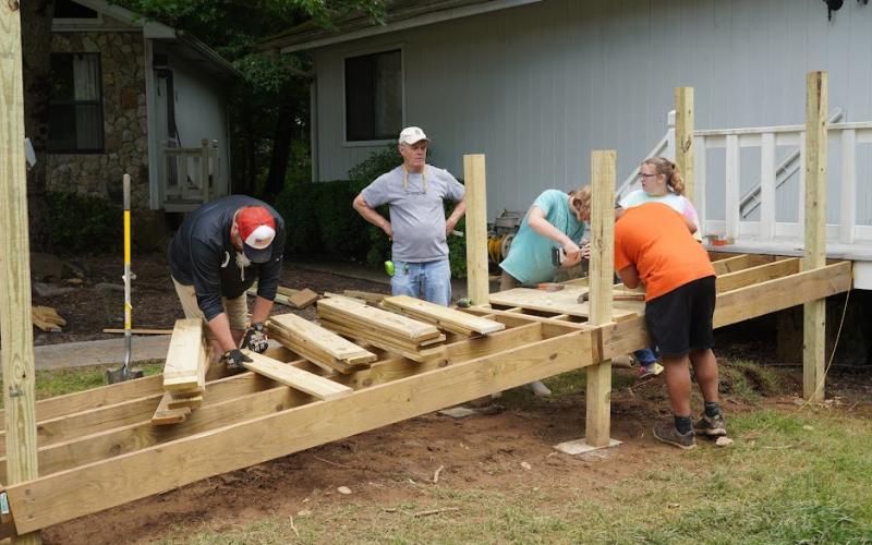 Photo submitted by Hinton Rural Life Center staff A summer mission team works on an accessibility ramp as part of Hinton’s Safe &amp; Healthy Home Repair ministry.