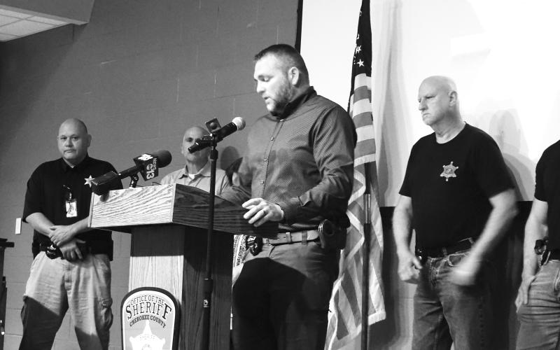 Randy Foster • editor@cherokeescout.com Cherokee County Sheriff Dustin Smith, at a news conference at Tri-County Community College on Monday evening, sadly announces the shooting death of one of his officers.