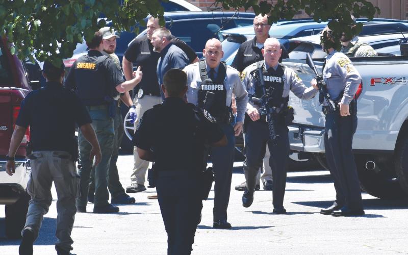 Randy Foster • editor@cherokeescout.com Law enforcement from several agencies collect at 75 Medical Park Lane in Peachtree on Monday afternoon following the deadly shooting of a detention center officer escorting an inmate to a medical appointment. Gov. Josh Stein ordered all U.S. and N.C. flags to be flown at half-staff through sunset Tuesday in honor of Officer Francisco Flattes
