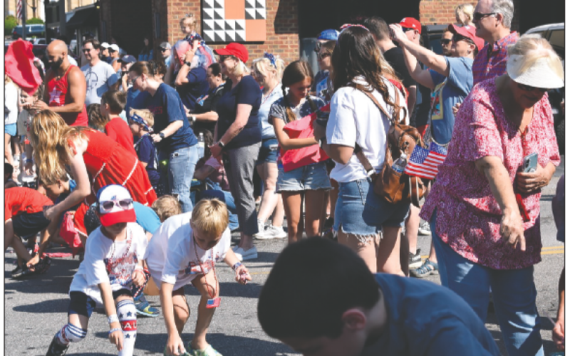 Becky Long • Clay County Progress Children and adults scramble to gather candy tossed out during the parade.