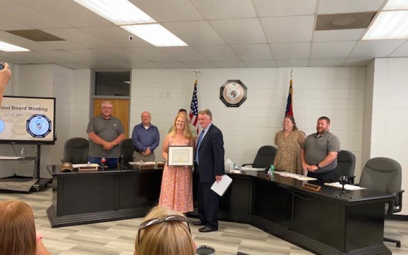 Marcia Barnes • Clay County Progress Front from left, Hayesville High School Science Teacher Amanda Coker received the Honored Educator Scholarship from the North Carolina Center for the Advancement of Teaching. The presentation was made by Dr. Brock Womble, NCCAT Executive Director during Clay County Schools Board of Education meeting on Monday, July 28. Back, Board Members Danny Jones. Robert Caldwell, Chairman Jason Shook, Superintendent Melissa Godfrey and Board Member Josh Ashe.