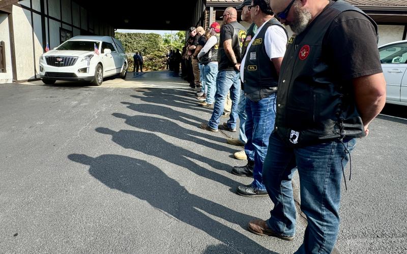 Randy Foster/editor@cherokeescout.com Veterans and law enforcement personnel stand in formation as the casket bearing the remains of Transport Detention Officer Francisco Flattes is removed from a hearse at Townson-Rose Funeral Home on Thursday, July 3. Flattes’ remains were returned to Murphy following an autopsy in Winston-Salem, with an escort by emergency responders.