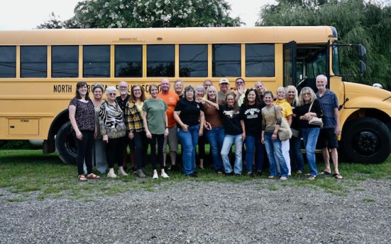 Sandra Hollifield • Photo Moonshine Mardi Gras members stuff the bus at the back-to-school-bash.