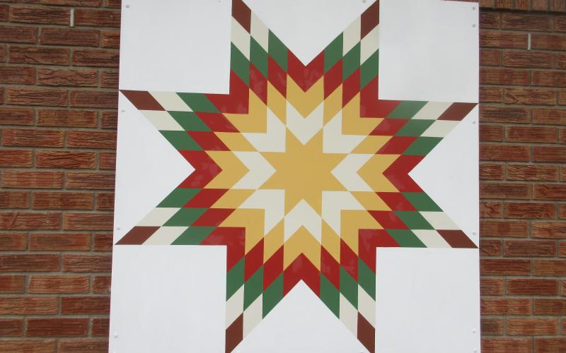 The Moss Memorial Library is home to one of the first 4 x 4 foot Barn Quilts displayed in downtown Hayesville. Colors are still vibrant after years on outside display and used as background for many photos.