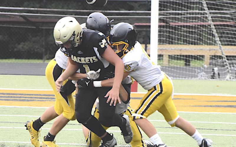 Gary Corsair • Clay County Progress Hayesville quarterback Luke Buckner, No. 1, tries to free himself so he can grab a fumbled football.