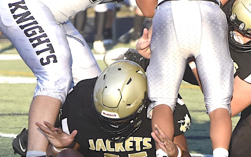 Gary Corsair • Clay County Progress Hayesville lineman Brock Garrett, No. 55, keeps his eyes on the prize as he reaches to recover a Robbinsville fumble