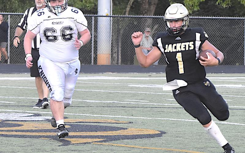 Gary Corsair • Clay County Progress Yellow Jackets signal caller Luke Buckner, No. 1, turns the corner for the way to a first down against the Black Knights.