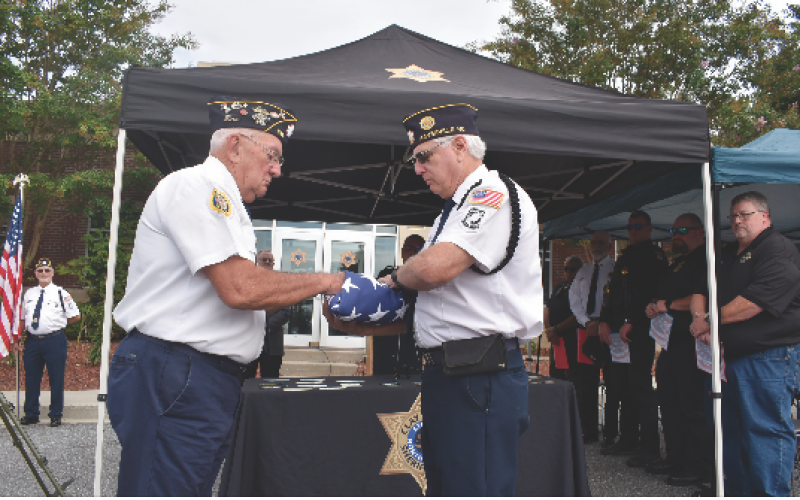 Becky Long • Clay County Progress American Legion members Rondall Brown and Phil Cantley conduct the Flag Folding ceremony for Thursday’s 9/11 Patriot’s Day remembrance event at the sheriff’s office.