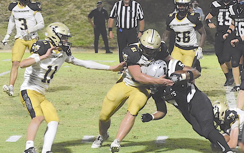 Gary Corsair • Clay County Progress Hayesville's Brendon Collins, No. 51, applies a bear hug to a Robbinsville back as Donivin Soto, No. 11, Colton Bruggers, No. 3, and Will Brown, No. 56, hustle over to assist.